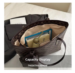 Top view of spacious brown monogram tote bag interior holding a tablet, books, and umbrella