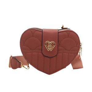 Chic heart-shaped crossbody bag with quilted texture and golden twist-lock buckle