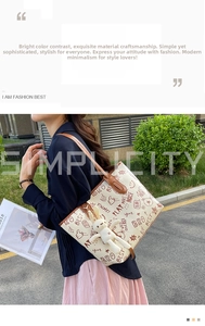 Detail of off-white cartoon tote bag with brown leather handles and plush rabbit charm