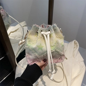 Tie-dye canvas bucket bag with star patterns and frayed edges for 2025 spring style