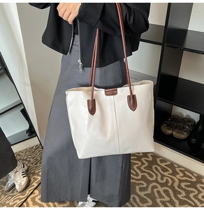 Détail d'un sac cabas en similicuir crème avec anses marron pour le quotidien chic