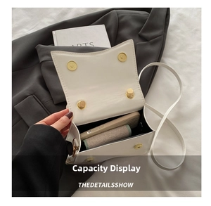 Internal view of the white leather crossbody bag showing space for phone and essentials