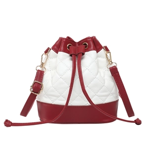 Quilted bucket bag with red and white contrast design and gold hardware accents