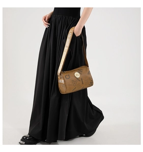 Close-up of a vintage brown cylindrical crossbody bag with gold buckle and letter prints