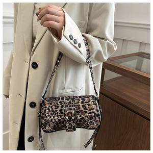 Close-up of leopard print shoulder bag with silver metal studs and Y2K buckle detail