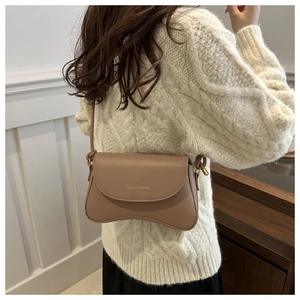 Brown leather crossbody bag with wave bottom design and Fashion & Bags text on cover
