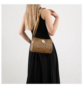 Detail of a brown cylindrical crossbody bag featuring vintage prints and a wide strap