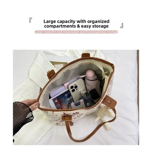 Top view of large graffiti tote bag showing interior storage for phone and accessories