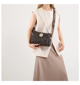 Detail of vintage brown monogram cylinder crossbody bag with wide printed shoulder strap