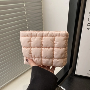Stylish light pink puffer hand bag with quilted design and soft pleated edges