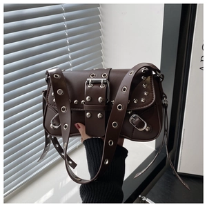 Close-up of leopard pattern punk shoulder bag with silver metal eyelets and buckle details