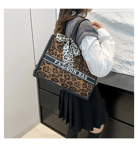 Détail du sac cabas léopard avec bande contrastée et foulard en soie décoratif