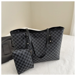 Close-up of vintage tote bag set with 'M' pattern and matching small pouch