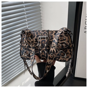 Detail of leopard print handbag featuring metallic rivets and silver eyelet studs