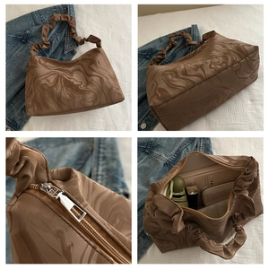 Detail of coffee marble pattern bag featuring ruched handle and silver zipper closure