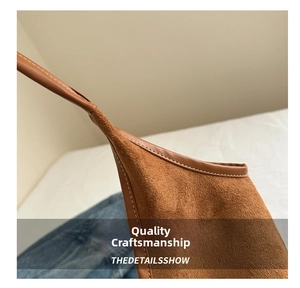 Close-up of the meticulous stitching and premium suede texture on a brown shoulder bag