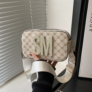 Chic cream-white crossbody camera bag with monogram pattern and bold SM letters