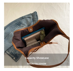 Macro view of brown leather tote bag interior showing large capacity for personal items