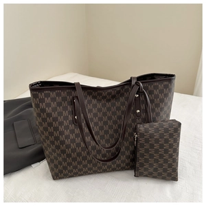 Detail view of large dark brown tote and matching pouch set with M-pattern logo print