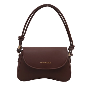 Minimalist dark brown leather shoulder bag with a curved base and gold lettering