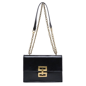 Glossy black leather crossbody bag with a gold geometric clasp and metal chain strap