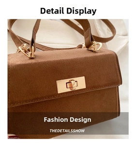 Detail view of the vintage faux suede brown handbag with gold square twist lock closure