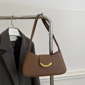 Minimalist dark brown leather underarm bag with gold crescent metal buckle