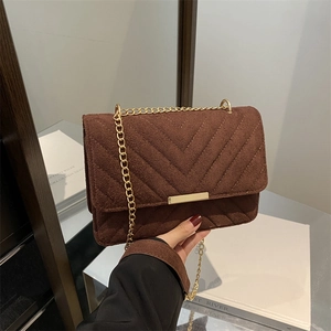 Brown chevron suede crossbody bag with elegant gold chain strap and metallic closure