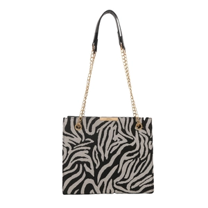 Fashionable zebra print shoulder bag with gold chain strap and metal trim details