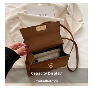 Detailed view showing internal storage capacity for smartphone in brown faux suede bag