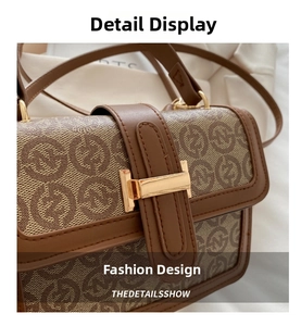 Close-up of retro printed flap bag featuring vintage pattern and golden T-shaped buckle