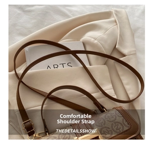 Detail of vintage brown monogram canvas handbag with leather trim and gold buckle