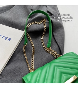 Detail of green PU crossbody bag featuring V-shaped quilting and gold metal chain strap