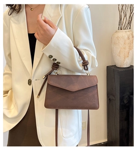 Minimalist brown square envelope handbag with knot handle and adjustable strap detail