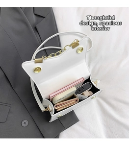Detail view of white crossbody bag interior showing spacious storage for essentials
