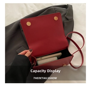 Interior view showing capacity of the red crossbody bag with phone and wallet