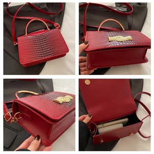 Red crocodile texture crossbody bag featuring a unique gold semi-circle metal handle
