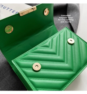 Close-up of vibrant green quilted handbag with gold magnetic clasp and V-shape stitching