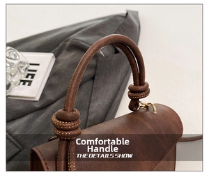 Detail showing the retro brown leather bag's thick knotted handle and fine stitching work