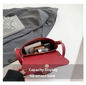 Top view showing the internal capacity of the burgundy leather bag with daily essentials