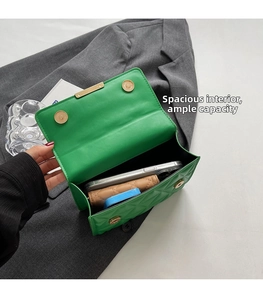 Interior view of green quilted chain bag showing capacity for phone and card holder