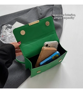 Detail view of green quilted crossbody bag interior showing spacious storage for essentials