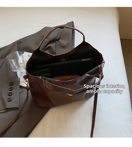 Spacious interior of dark brown PU leather tote bag shown with tablet for scale