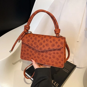 Brown PU leather shoulder bag with clover embossing and decorative knot handle detail