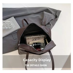 Top view of spacious dark brown leather tote bag interior with everyday essentials