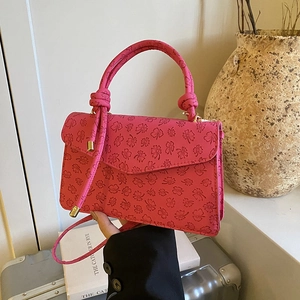 Chic magenta clover embossed leather crossbody bag with top handle for women