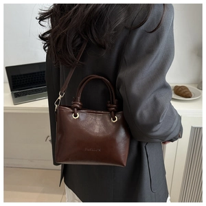 Brown leather bucket bag detail with Fashion embossing and detachable shoulder strap