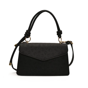 Elegant black embossed clover patterned crossbody bag with golden hardware and top handle