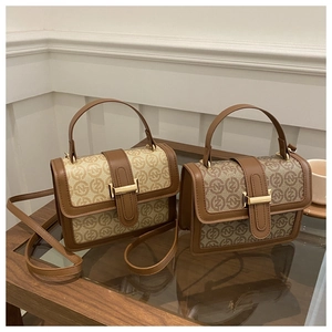 Detail of vintage canvas and brown leather crossbody bag with repeat monogram print