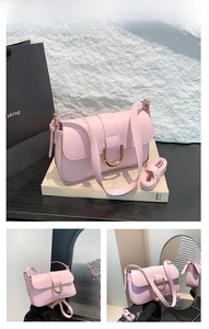 Detailed close-up of pink baguette bag showing metallic horseshoe buckle and leather texture